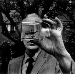 Joseph Cornell holding an Untitled Bottle Object, photograph by Duane Michals